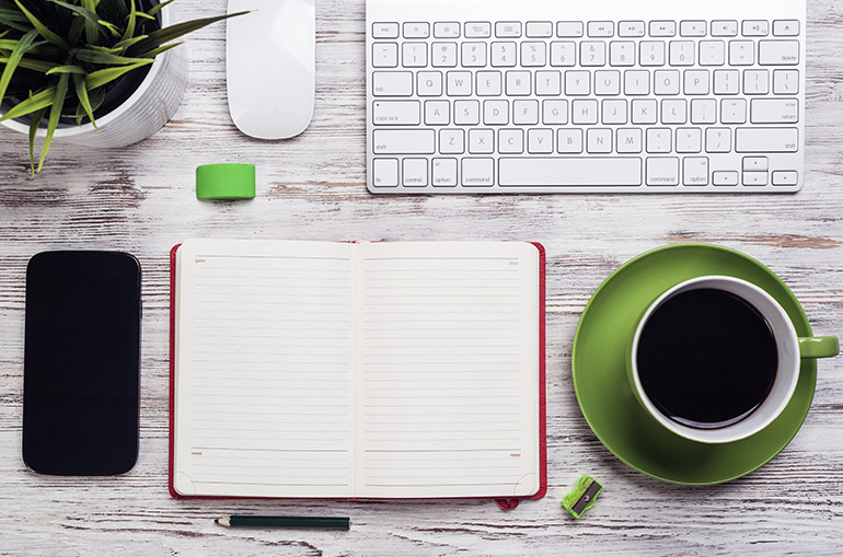 An organised desk with a cup of coffee
